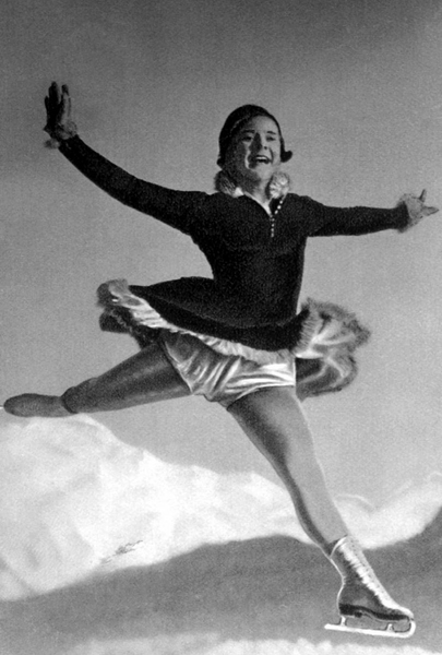 Black and white photo of a figure skater leaping.
